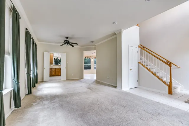 a view of a hallway with entryway and stairs