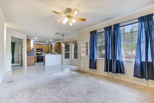 a view of a livingroom with furniture and windows