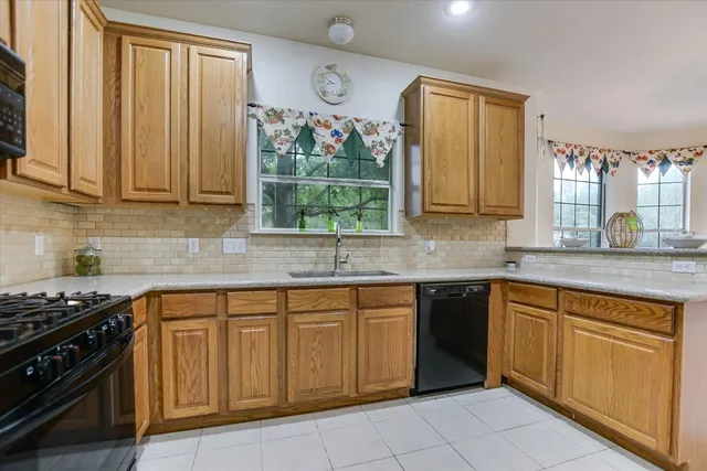 a kitchen with cabinets appliances and a window
