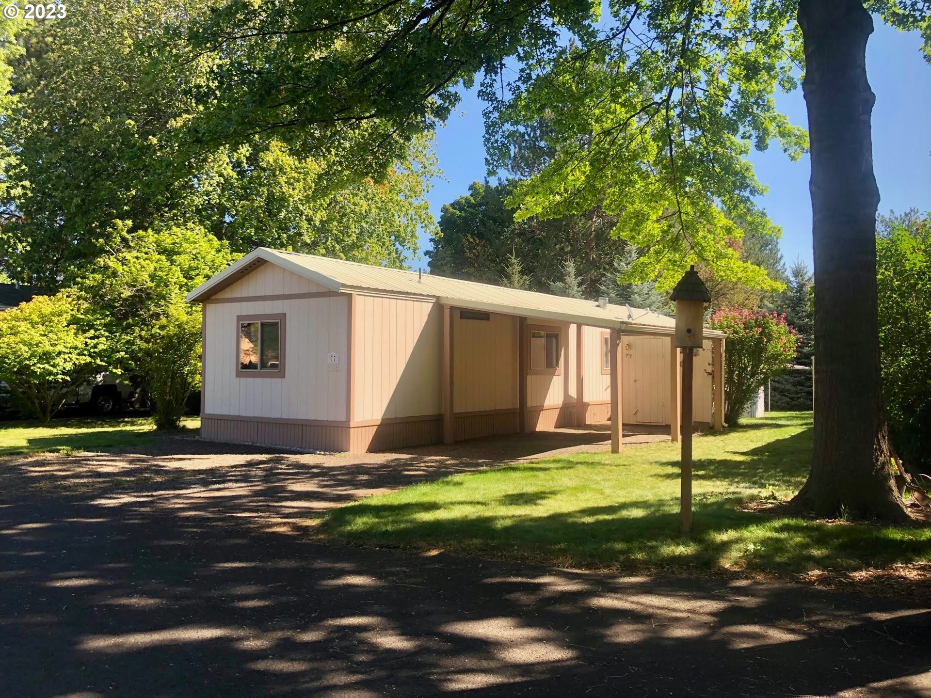 1809 26th Street, Unit 77 La Grande, OR 97850 - Photo 1 of 41 a view of a house with backyard and tree