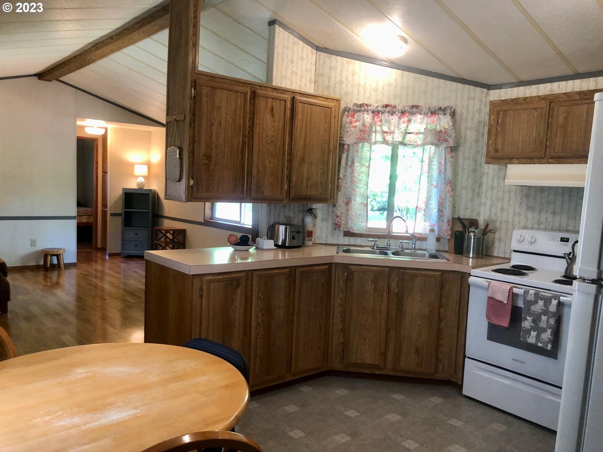 1809 26th Street, Unit 77 La Grande, OR 97850 - Photo 11 of 41 a kitchen with stainless steel appliances granite countertop a sink a stove a counter space and cabinets