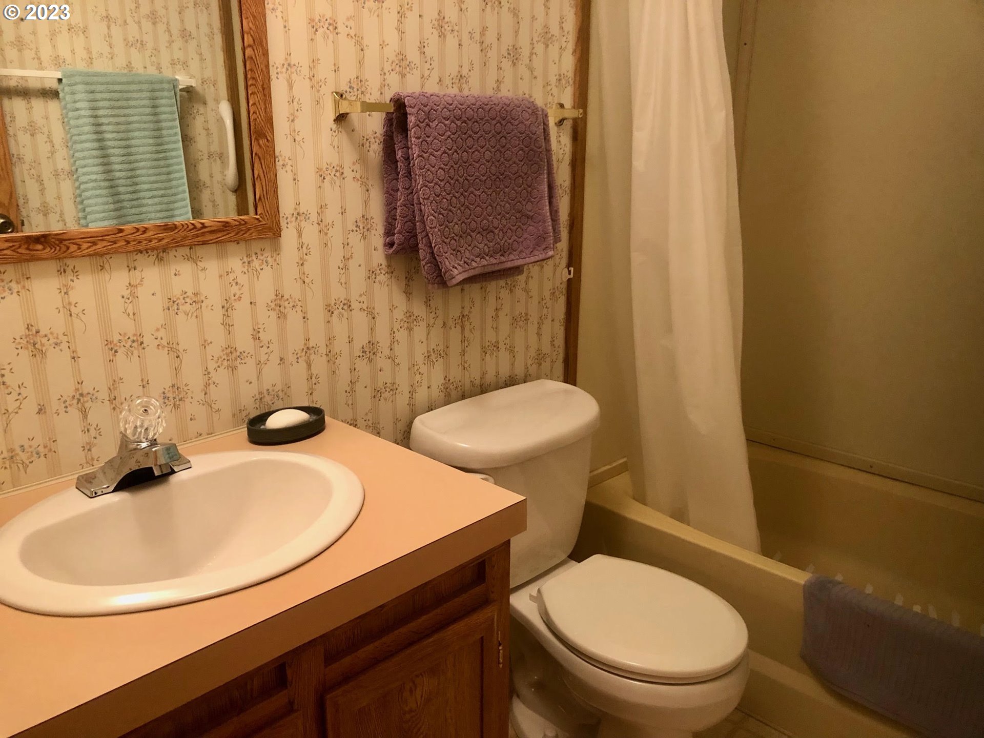 1809 26th Street, Unit 77 La Grande, OR 97850 - Photo 23 of 41 a bathroom with a sink a toilet and mirror