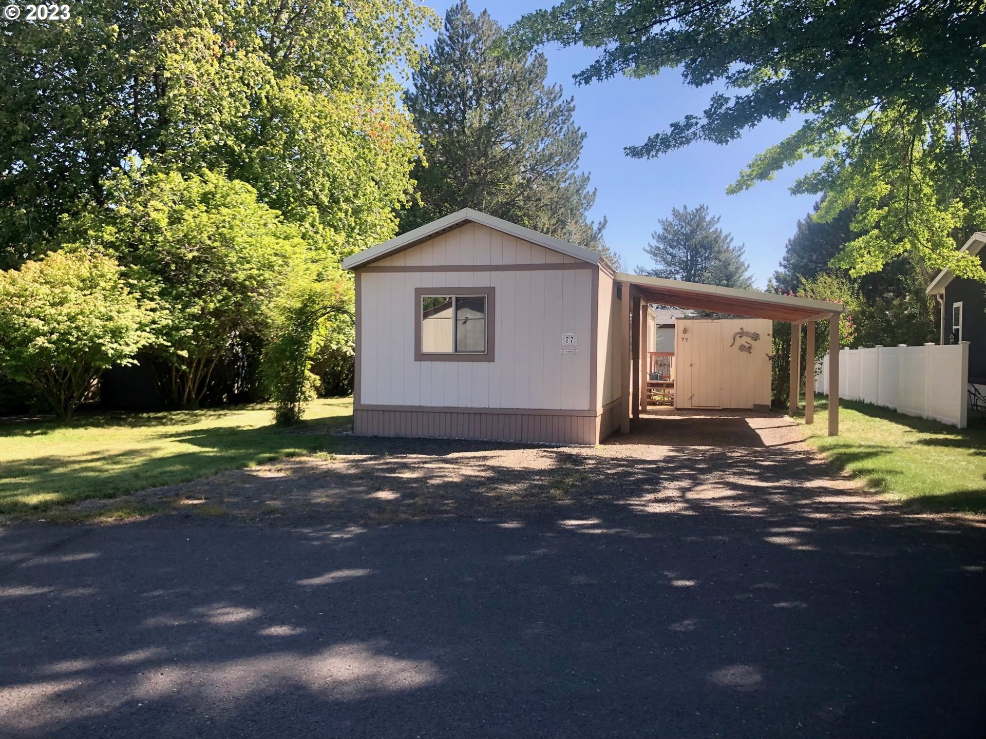 1809 26th Street, Unit 77 La Grande, OR 97850 - Photo 31 of 41 a view of a house with backyard and a tree