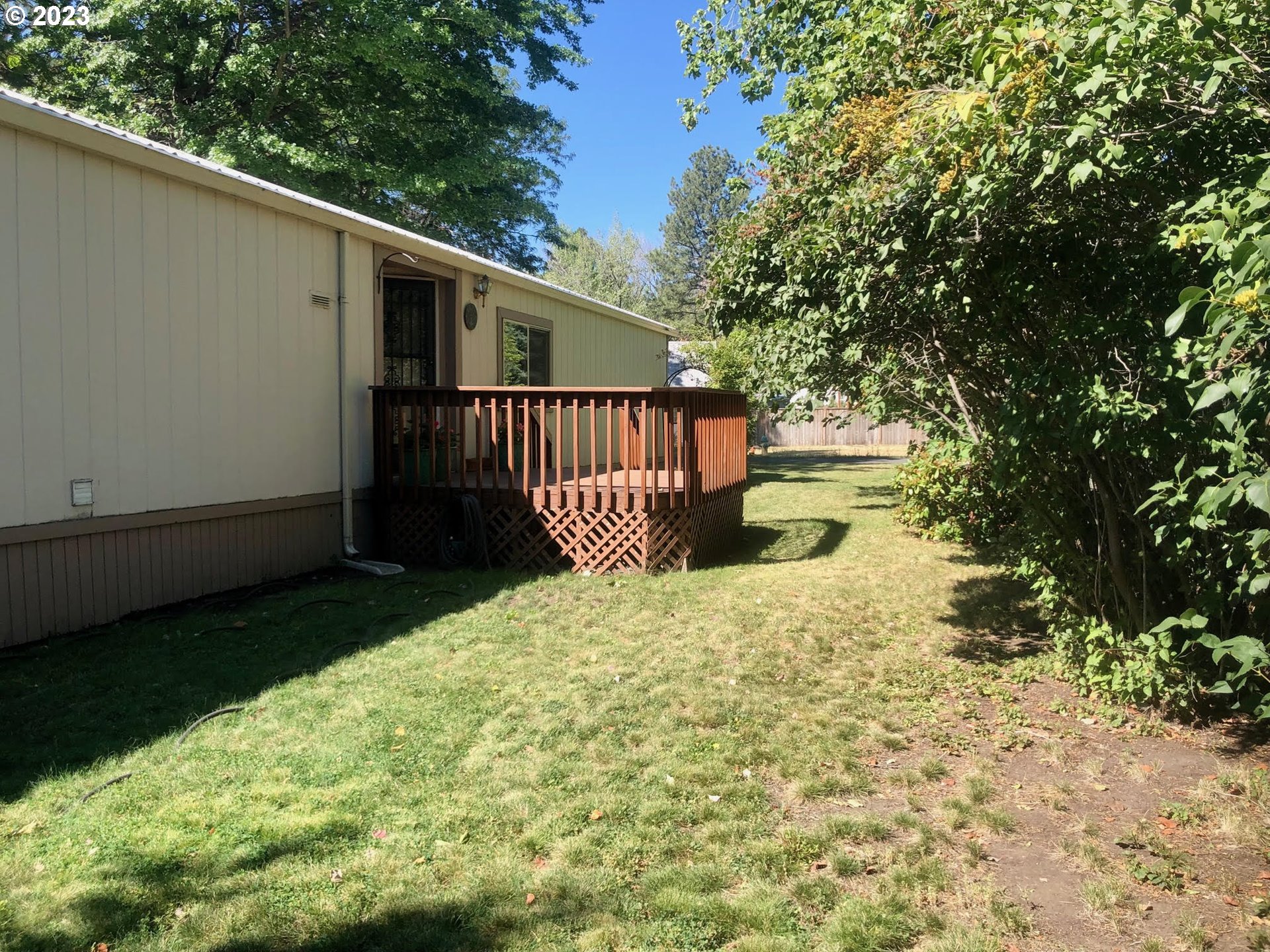1809 26th Street, Unit 77 La Grande, OR 97850 - Photo 41 of 41 a view of balcony with small garden and wooden fence