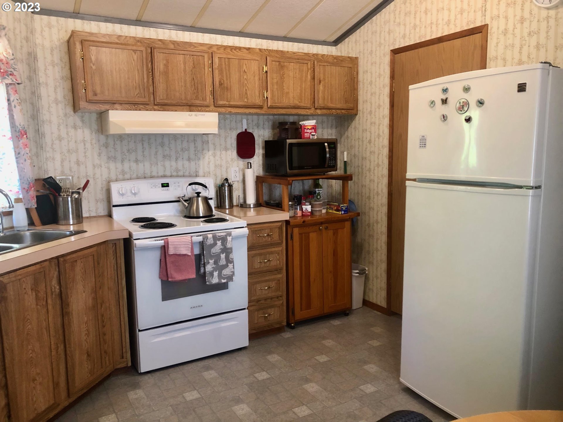 1809 26th Street, Unit 77 La Grande, OR 97850 - Photo 9 of 41 a kitchen with a refrigerator sink and cabinets