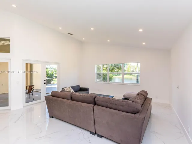 a kitchen with stainless steel appliances kitchen island granite countertop a refrigerator and a stove top oven