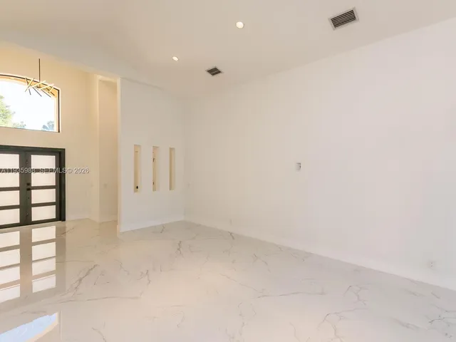 a living room with furniture and kitchen view
