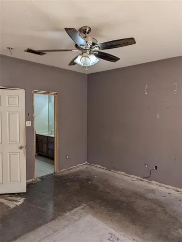 a view of a livingroom with a ceiling fan and window