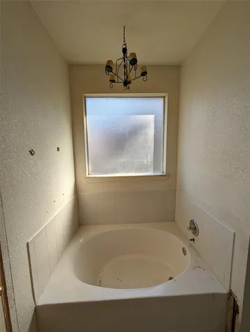 a bath tub sitting in a bathroom next to a sink