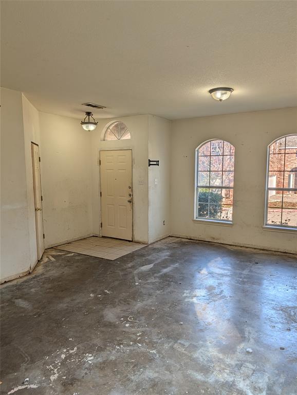 2301 Springmere Drive Arlington, TX 76012 - Photo 4 of 34 an empty room with wooden floor and windows