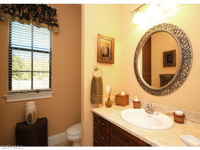 1491 Oakes Boulevard Naples, FL 34119 - Photo 11 of 15 a bathroom with a sink and a mirror