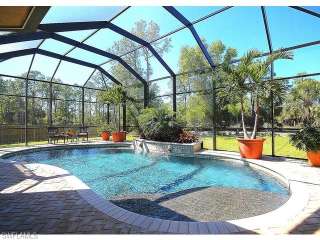 1491 Oakes Boulevard Naples, FL 34119 - Photo 13 of 15 a view of swimming pool with a yard