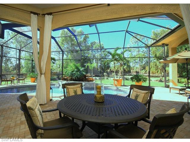 1491 Oakes Boulevard Naples, FL 34119 - Photo 14 of 15 a view of an outdoor sitting area with a table and chairs