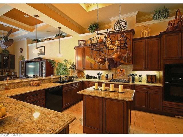 1491 Oakes Boulevard Naples, FL 34119 - Photo 3 of 15 a kitchen with stainless steel appliances granite countertop a sink a stove and a wooden cabinets
