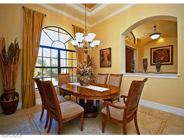 1491 Oakes Boulevard Naples, FL 34119 - Photo 5 of 15 a view of a dining room with furniture and chandelier