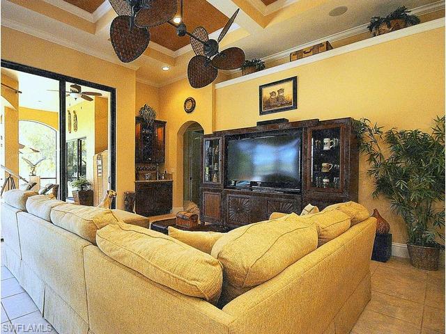 1491 Oakes Boulevard Naples, FL 34119 - Photo 6 of 15 a living room with couches a flat screen tv and a floor to ceiling window