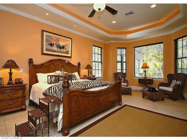 1491 Oakes Boulevard Naples, FL 34119 - Photo 8 of 15 a bedroom with furniture and large windows