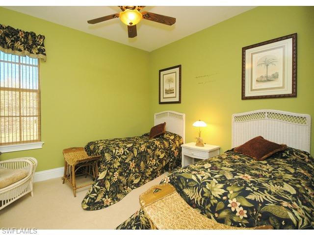 1491 Oakes Boulevard Naples, FL 34119 - Photo 10 of 15 a bedroom with a bed and a couch