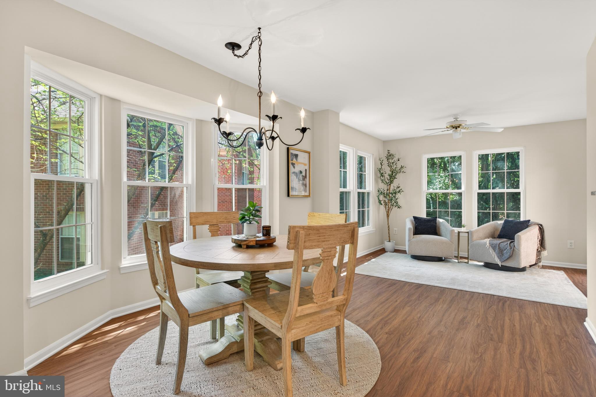 1409 Park Garden Lane Reston, VA 20194 - Photo 13 of 41 a dining room with furniture a chandelier and wooden floor
