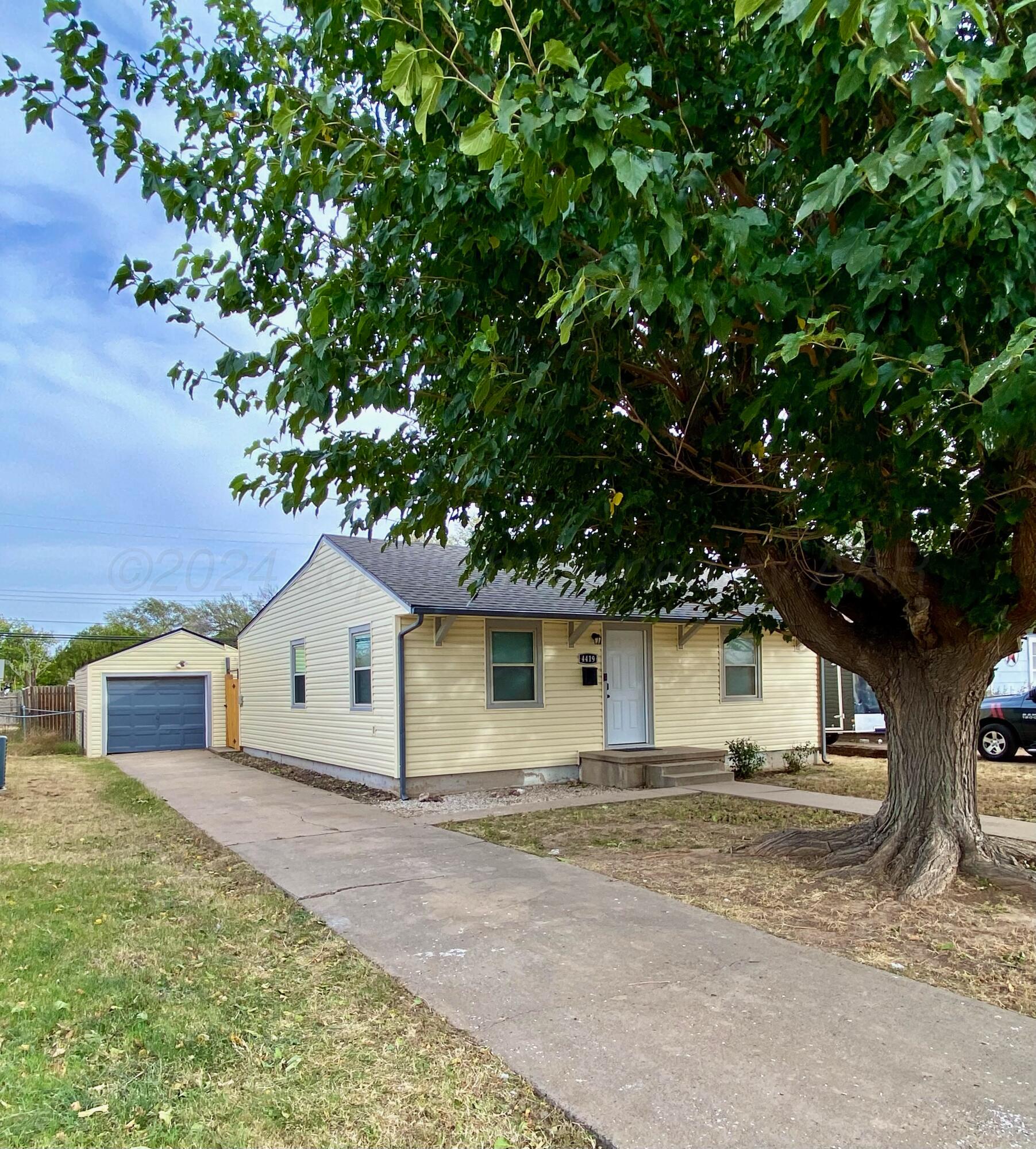 4419 Bowie Street Amarillo, TX 79110 - Photo 15 of 15 a view of a house with a yard