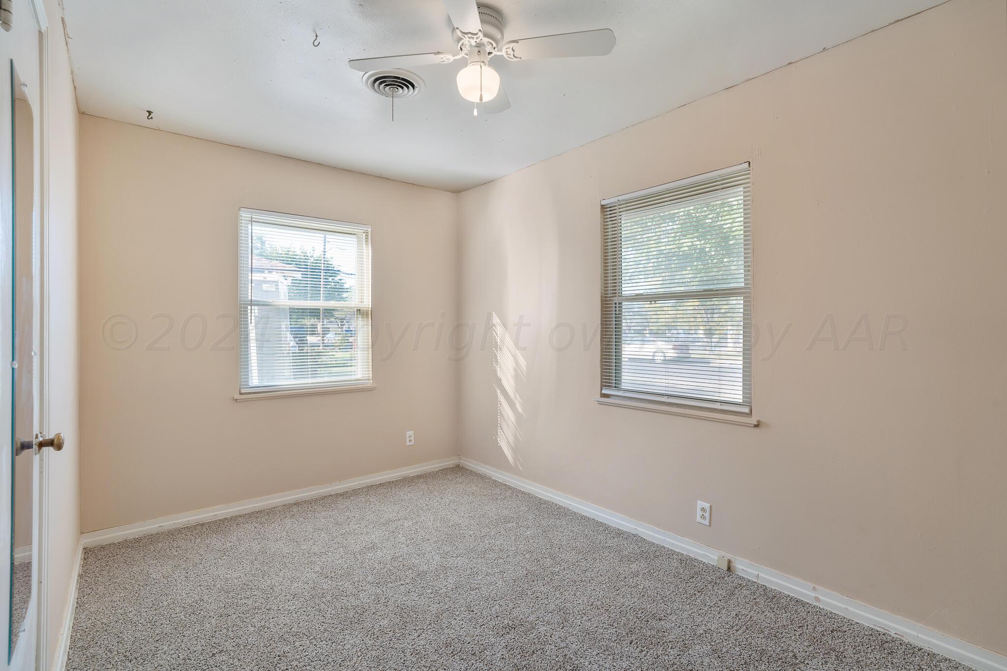 4419 Bowie Street Amarillo, TX 79110 - Photo 9 of 15 an empty room with windows and fan