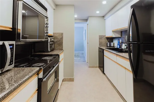 a stove top oven sitting inside of a kitchen