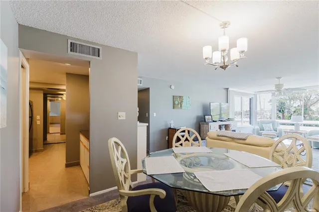 a living room with furniture fireplace and a large window