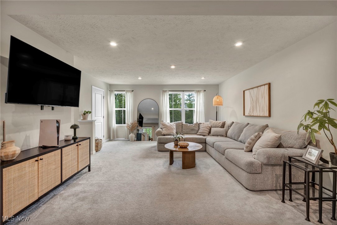 191 Raintree Lane Painesville, OH 44077 - Photo 3 of 35 Living room featuring light colored carpet, a textured ceiling, and recessed lighting
