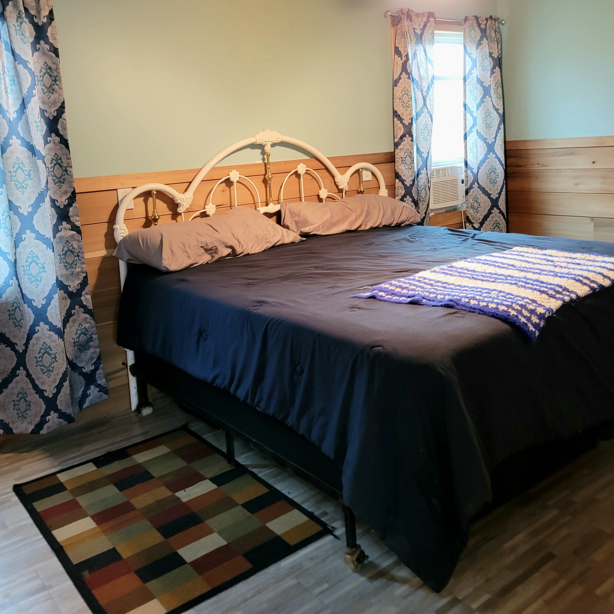 485 Creekside View Lane Decaturville, TN 38329 - Photo 8 of 31 a bed sitting in a bedroom next to a window