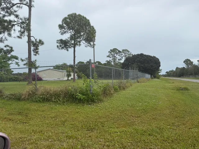 a large bedroom with a bed and glass door