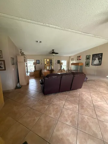 a living room with couches and kitchen view