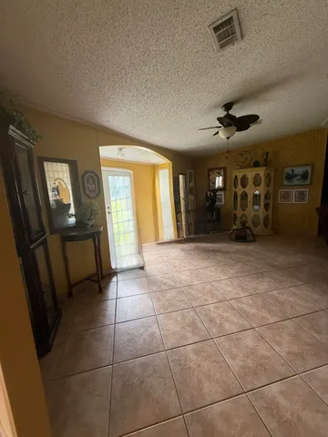 a spacious bedroom with a bed and a table in it