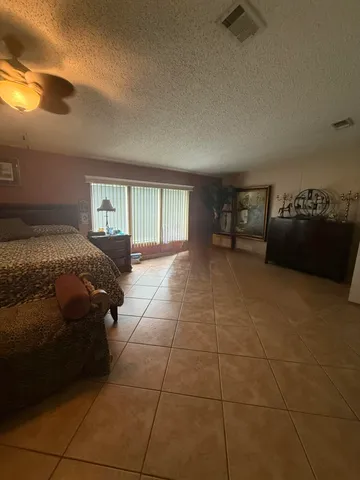 a bed sitting in a room next to a window