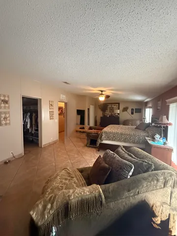 a bedroom with a bed and a couch