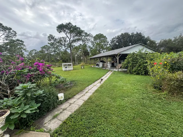 a view of outdoor space with swimming pool and green space