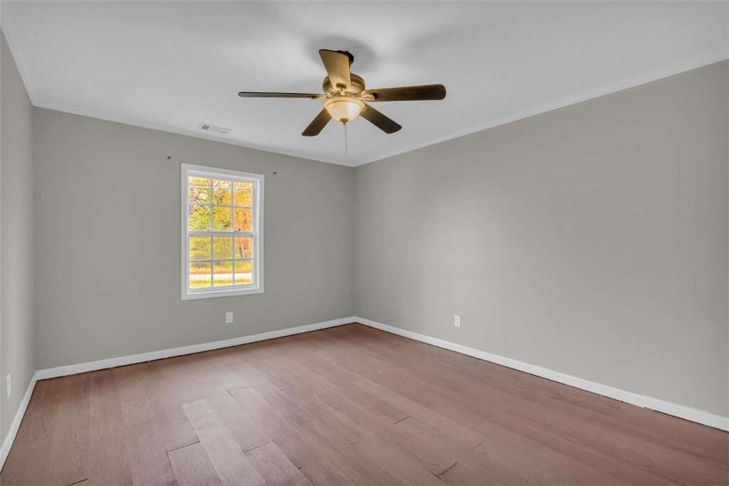 11118 City Pond Road Covington, GA 30014 - Photo 13 of 24 wooden floor in an empty room with a window