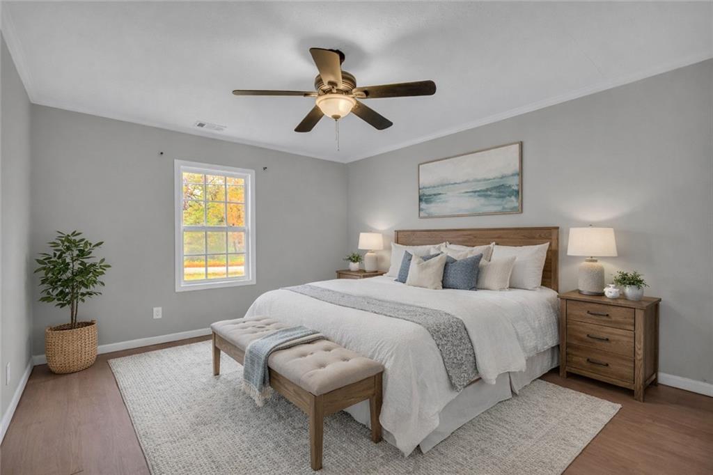 11118 City Pond Road Covington, GA 30014 - Photo 14 of 24 a bedroom with a bed and a chandelier