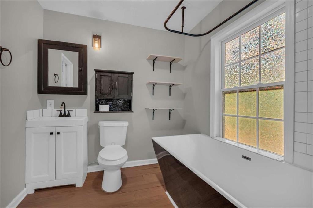 11118 City Pond Road Covington, GA 30014 - Photo 15 of 24 a bathroom with a toilet sink and mirror