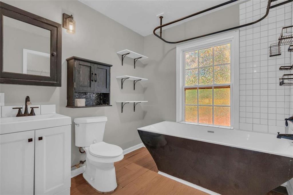 11118 City Pond Road Covington, GA 30014 - Photo 16 of 24 a bathroom with a sink a toilet and a mirror
