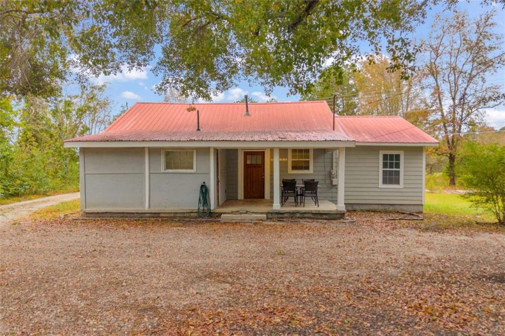 11118 City Pond Road Covington, GA 30014 - Photo 18 of 24 a front view of a house with a garden