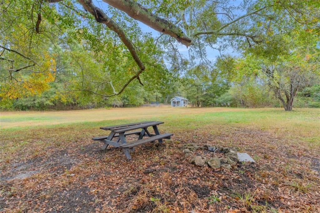 11118 City Pond Road Covington, GA 30014 - Photo 20 of 24 a view of a yard with a bench and trees