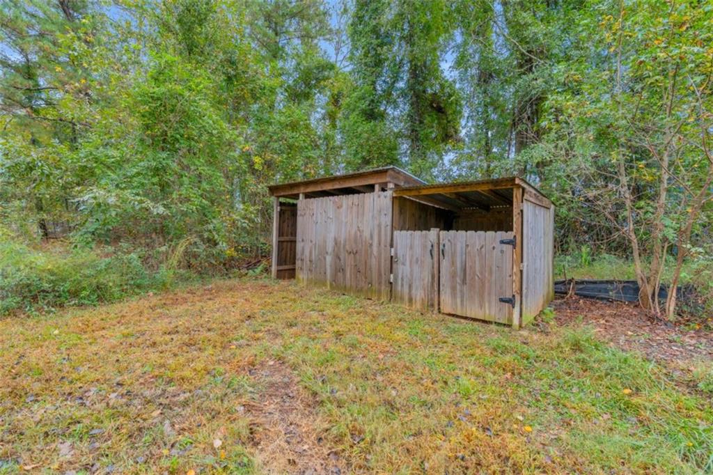 11118 City Pond Road Covington, GA 30014 - Photo 24 of 24 a backyard of a house with plants and tree