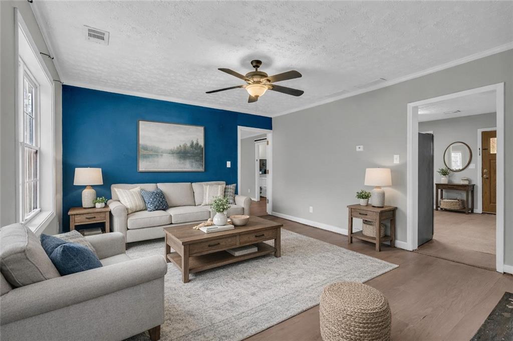 11118 City Pond Road Covington, GA 30014 - Photo 4 of 24 a living room with furniture and a chandelier
