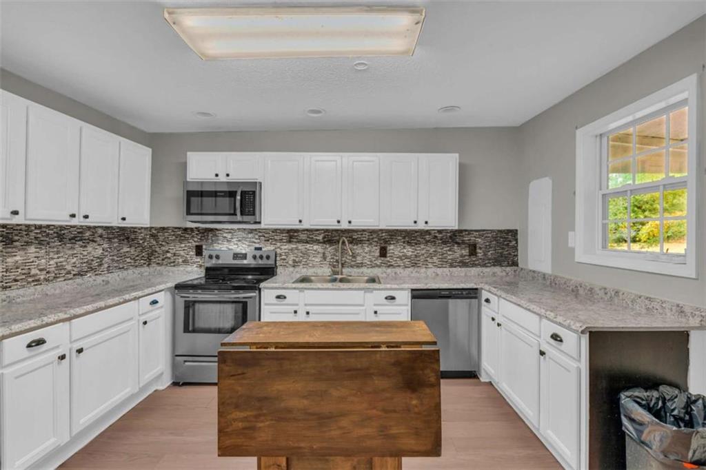 11118 City Pond Road Covington, GA 30014 - Photo 10 of 24 a kitchen with appliances cabinets and a sink