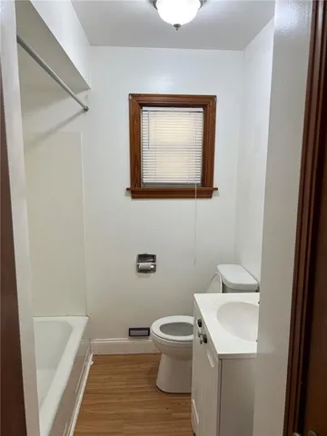 a bathroom with a toilet a sink and bathtub