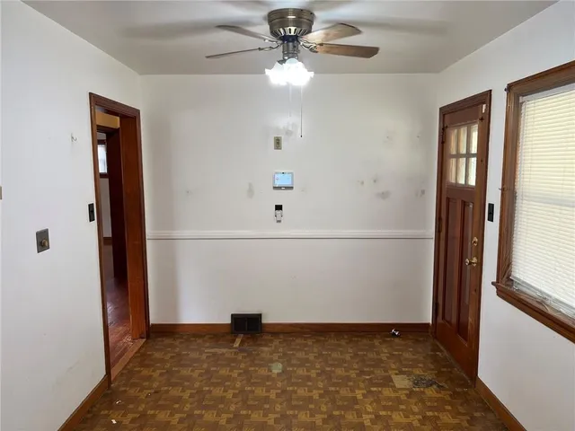 a view of a livingroom with a ceiling fan and window