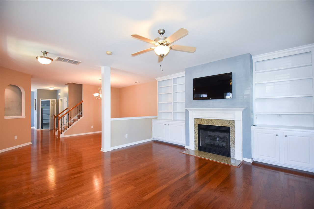 2712 Cloud Mist Circle Raleigh, NC 27614 - Photo 3 of 30 9' smooth ceilings and beautiful hardwood floors throughout main level. Spacious Living Room w/CF, lots of windows, and granite-clad gas log fireplace flanked by cabinets & bookcases. Open to Dining Room. Living Room