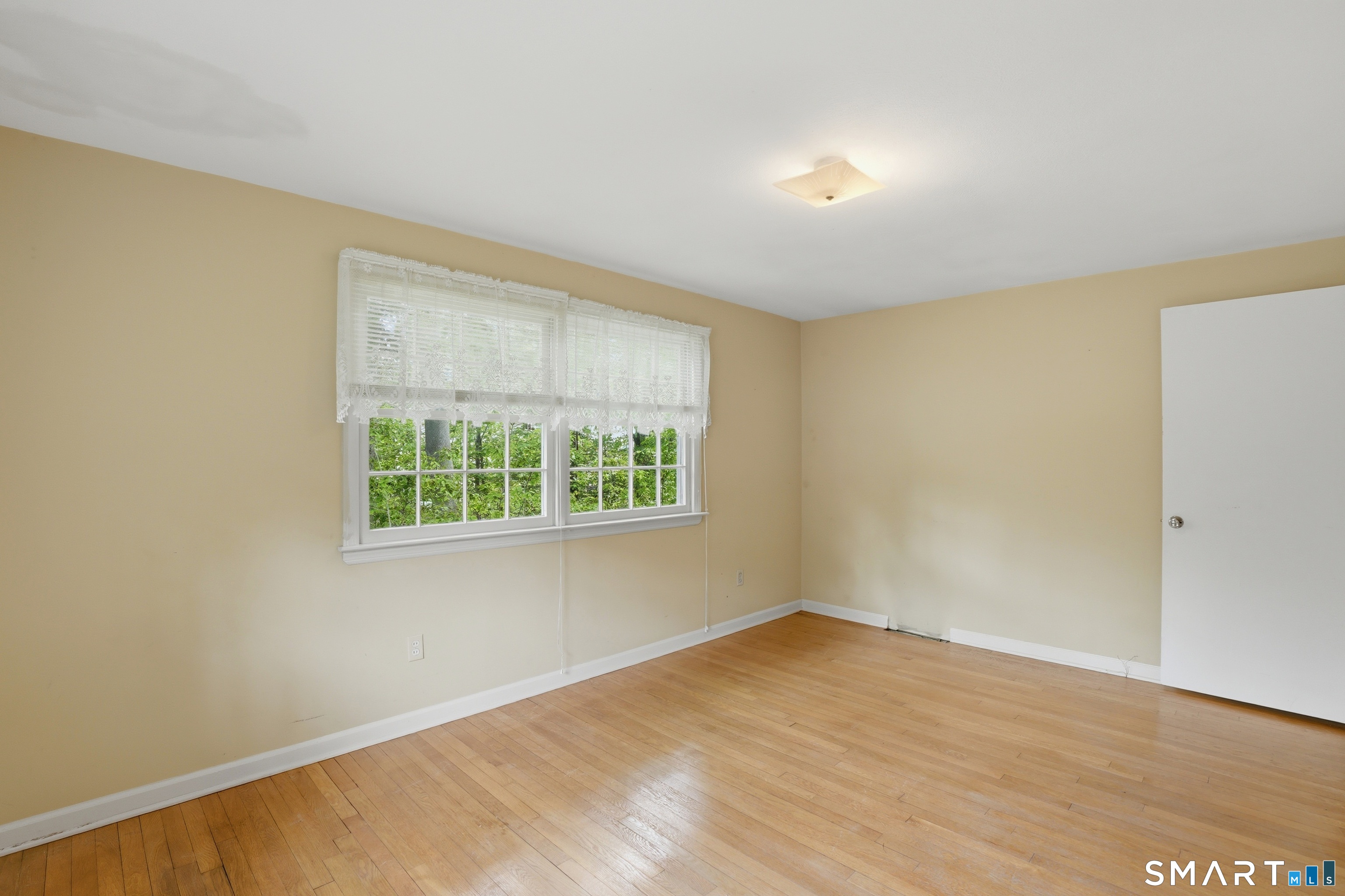 731 Still Hill Road Hamden, CT 06518 - Photo 18 of 40 a view of an empty room with wooden floor and a window