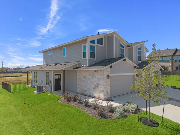 a view of a house with a backyard
