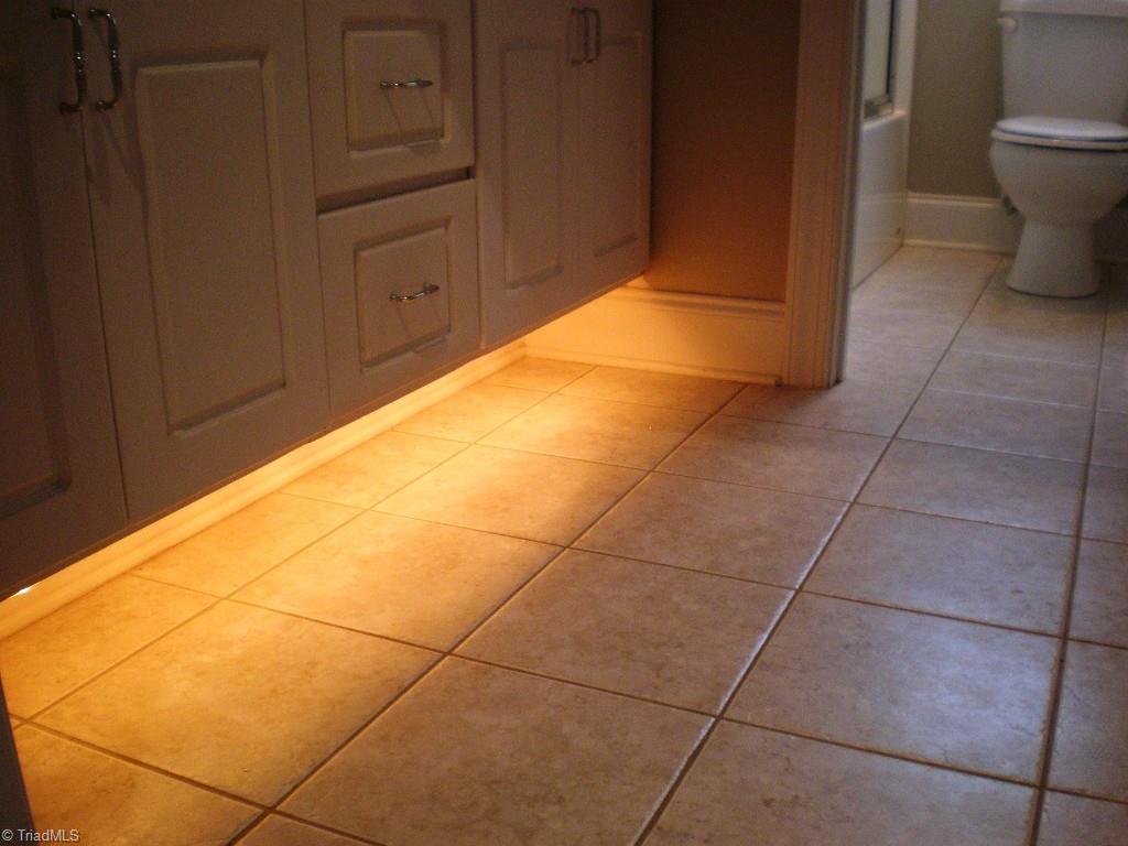 8506 Case Ridge Drive Oak Ridge, NC 27310 - Photo 21 of 30 Hall Bath with Toe Kick Accent Lighting. Vanity Area is Separated from Tub and Toilet Area to Allow for Privacy with Multiple Users